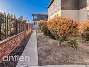 Los Angeles apartment for rent - A residential area with a house, a fence, and a sidewalk.