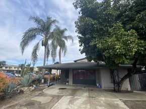 Compton apartment for rent - A house with a driveway and a tree in front.