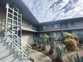 Compton apartment for rent - A concrete staircase leads to a building with a metal railing.