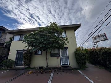 Los Angeles apartment for rent - A yellow house with a tree in front of it.
