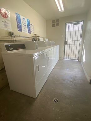 Los Angeles apartment for rent - A white sink with a digital display is in a room with a metal gate.