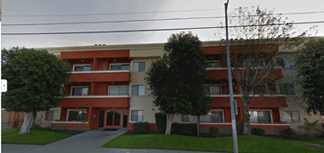 North Hollywood apartment for rent - A red and white building with a tree in front.