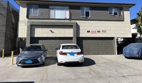 Los Angeles apartment for rent - Two cars are parked in front of a garage door.