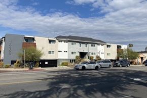 Van Nuys apartment for rent - A modern building with a parking lot in front.