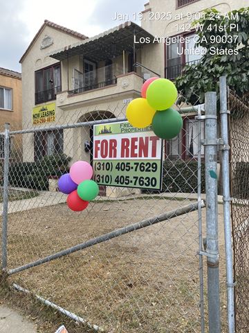 Los Angeles apartment for rent - A house with a fence and a sign that says "FOR RENT" in front of it.