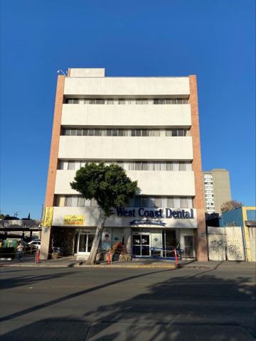 Los Angeles apartment for rent - A West Coast Dental building with a tree in front.
