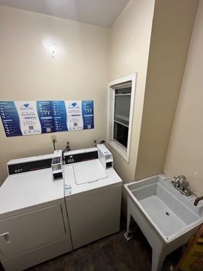 Los Angeles apartment for rent - A laundry room with a washer and dryer and a sink.