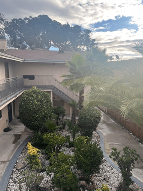 Inglewood apartment for rent - A house with a balcony and a garden in front.