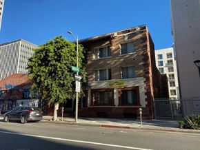 Los Angeles apartment for rent - A building with a sign that says "Now Hiring" on the front.