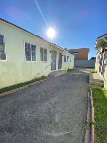 Inglewood apartment for rent - A sunny day at a residential area with a building and a paved area.