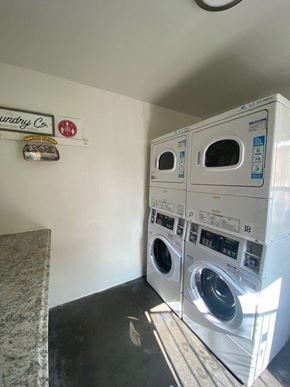 Los Angeles apartment for rent - A wall with a sign that says "dryry Co" and a stack of washers and dryers.