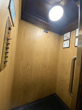 Los Angeles apartment for rent - A wooden hallway with a light on the ceiling and pictures on the wall.