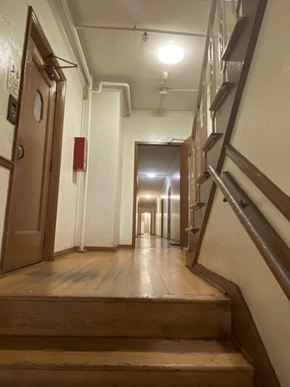 Los Angeles apartment for rent - A long hallway with a staircase on the right and a door on the left.