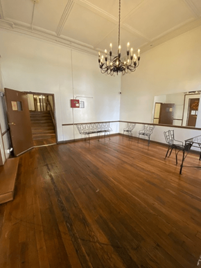 Los Angeles apartment for rent - A large room with wooden floors and a chandelier.