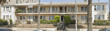 Los Angeles apartment for rent - A white building with a balcony and a black fence.