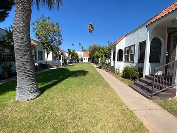 Los Angeles apartment for rent - A row of houses with a palm tree in the distance.