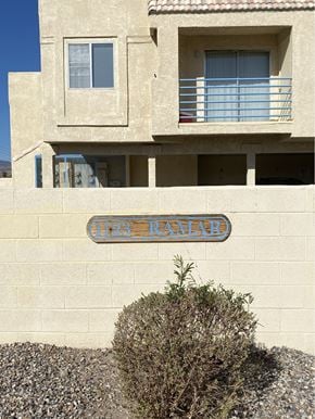 Bullhead City apartment for rent - A tan building with a blue sign that says "Ramadan".