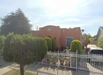 Los Angeles apartment for rent - A building with a white fence in front of it.
