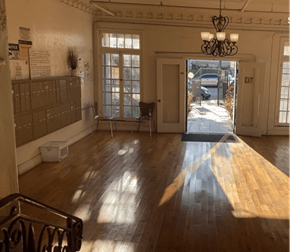 Los Angeles apartment for rent - A room with wooden floors and a chandelier.