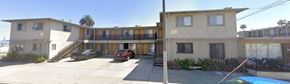 San Pedro apartment for rent - A two story house with a car parked in front.