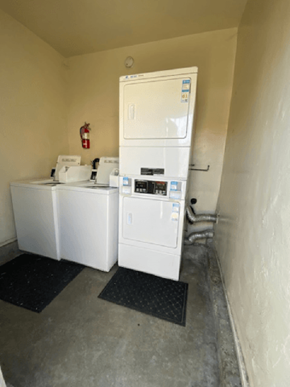 Los Angeles apartment for rent - A white refrigerator and washing machine in a small room.