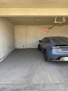 Los Angeles apartment for rent - A blue car is parked in a garage.