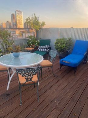 Los Angeles apartment for rent - A wooden deck with a table, chairs, and plants.