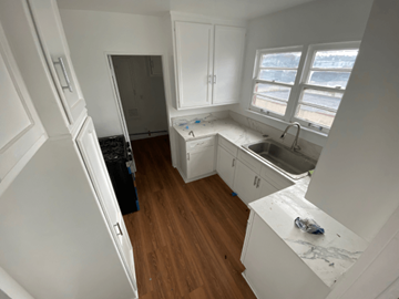 Los Angeles apartment for rent - A kitchen with white cabinets and a white fridge.