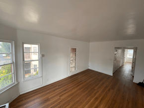 Los Angeles apartment for rent - A room with wooden floors and white walls.