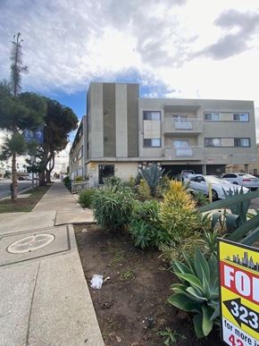 Los Angeles apartment for rent - A building with a sign that says "FOR 323" in front of it.