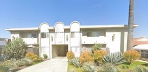 Los Angeles apartment for rent - A white modern house with a palm tree in front.