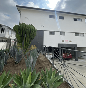 Los Angeles apartment for rent - A white building with the number 1954 on it.