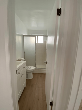 Los Angeles apartment for rent - A white bathroom with a toilet, sink, and shower.