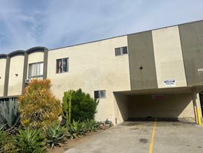 Los Angeles apartment for rent - A concrete building with a parking garage in front.