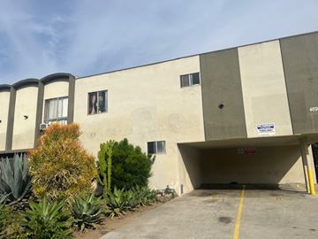 Los Angeles apartment for rent - A concrete building with a parking garage in front.