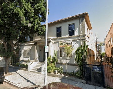 Los Angeles apartment for rent - A house with a sign that says "NOW LEASING" is located on a street.