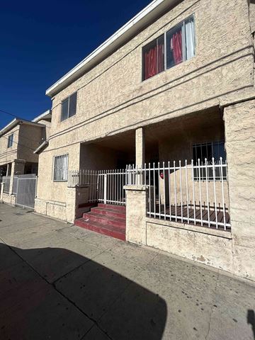 Los Angeles apartment for rent - A building with a red staircase leading to a door.