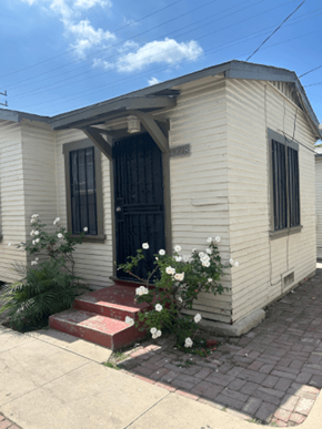 Los Angeles apartment for rent - A small white house with a black door and windows.