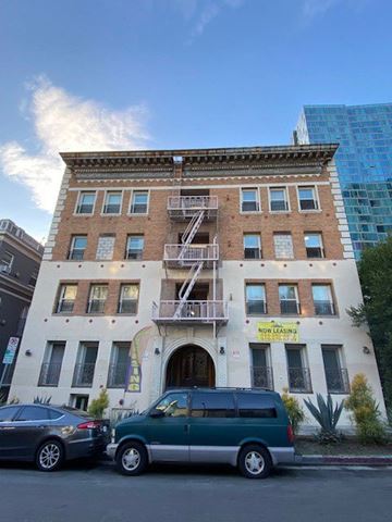 Los Angeles apartment for rent - A building with a sign that says "NO LEASING" is in front of a blue building.