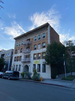 Los Angeles apartment for rent - A building with a sign that says "For Rent" is on the corner of a street.