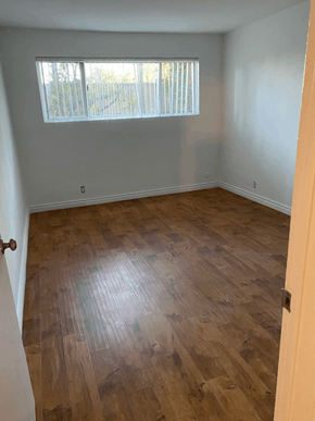 Los Angeles apartment for rent - A room with wooden flooring and a window with blinds.