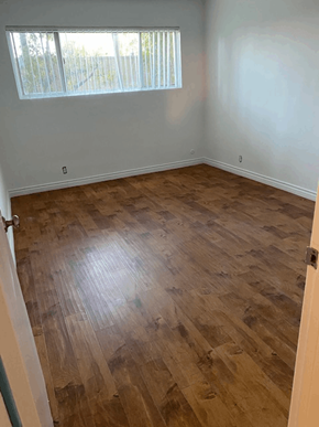 Los Angeles apartment for rent - A room with wooden flooring and a window with blinds.