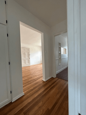 Los Angeles apartment for rent - A hallway with a wooden floor and white walls.