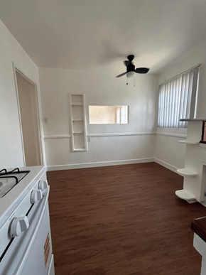 Los Angeles apartment for rent - A white stove in a room with wooden floors and a window.