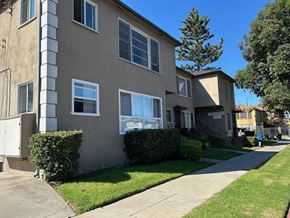 Los Angeles apartment for rent - A beige apartment building with a green lawn in front.