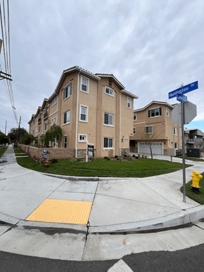 San Gabriel apartment for rent - A street corner with a crosswalk and a building in the background.