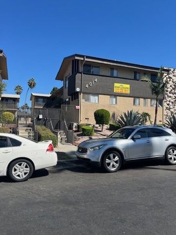 Los Angeles apartment for rent - A silver car is parked in front of a building with a sign that reads "NO PARKING ANYTIME.".