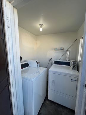 Inglewood apartment for rent - A white washing machine and dryer in a small laundry room.