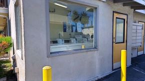 San Pedro apartment for rent - A yellow pole stands in front of a building with a window.