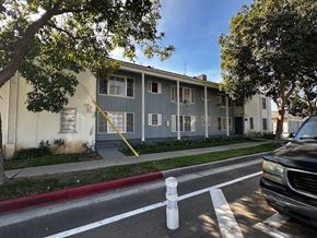 Los Angeles apartment for rent - A black car is parked on the side of a street.